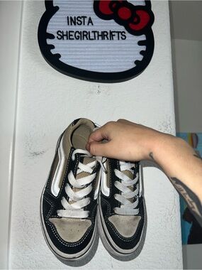 khaki and black low top vans